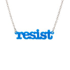 Bright blue Resist necklace in typewriter font hanging on a silver chain against a white background. 