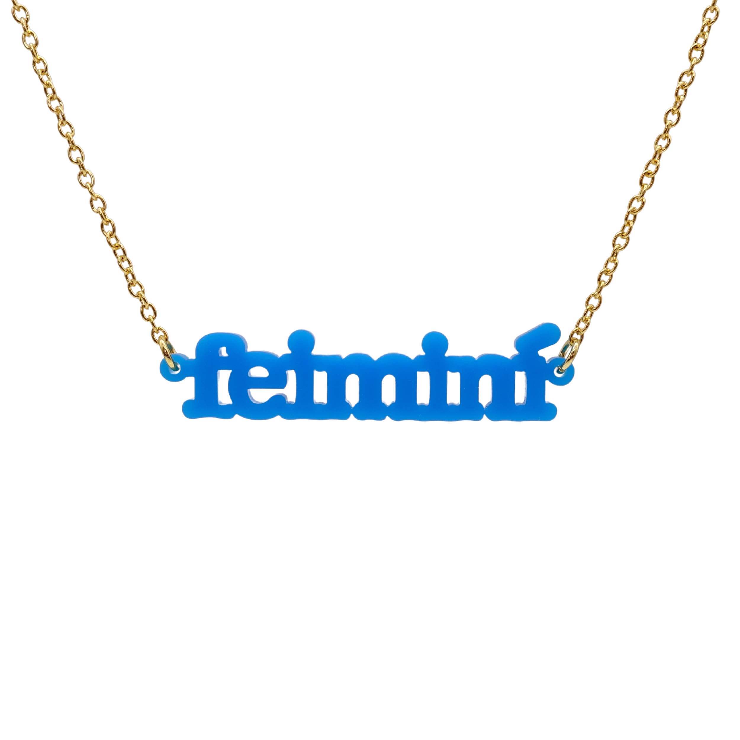 Irish Gaelic Feiminí necklace in matte bright blue, shown hanging against a white background. 