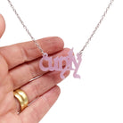 Little Cunty necklace in shell pink shown hanging on a stainless steel chain. 