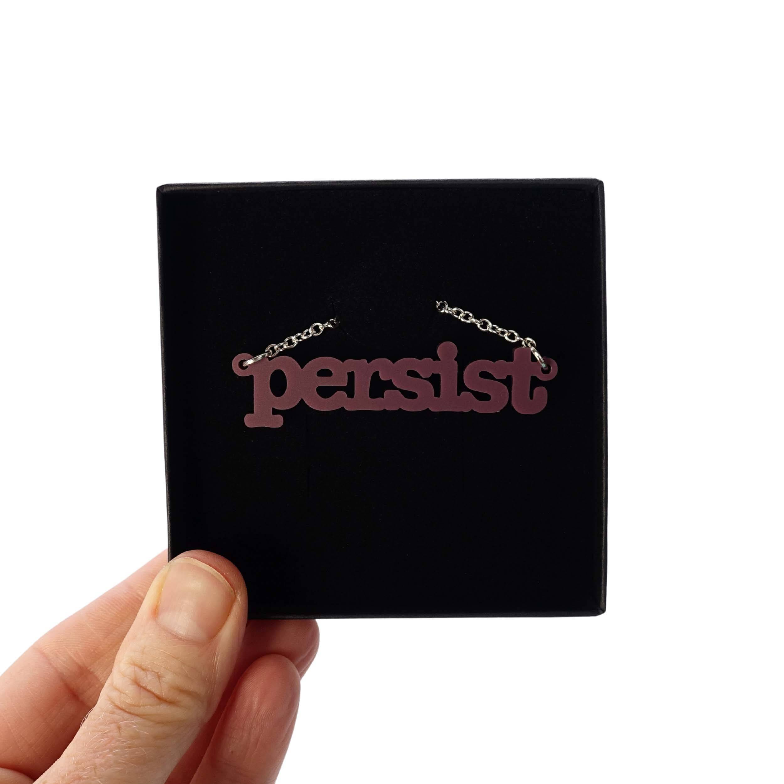 Cassis Persist necklace shown in a Wear and Resist gift box. 