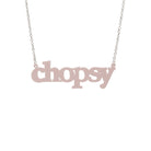 Chalk pink Chopsy necklace shown hanging against a white backround. 