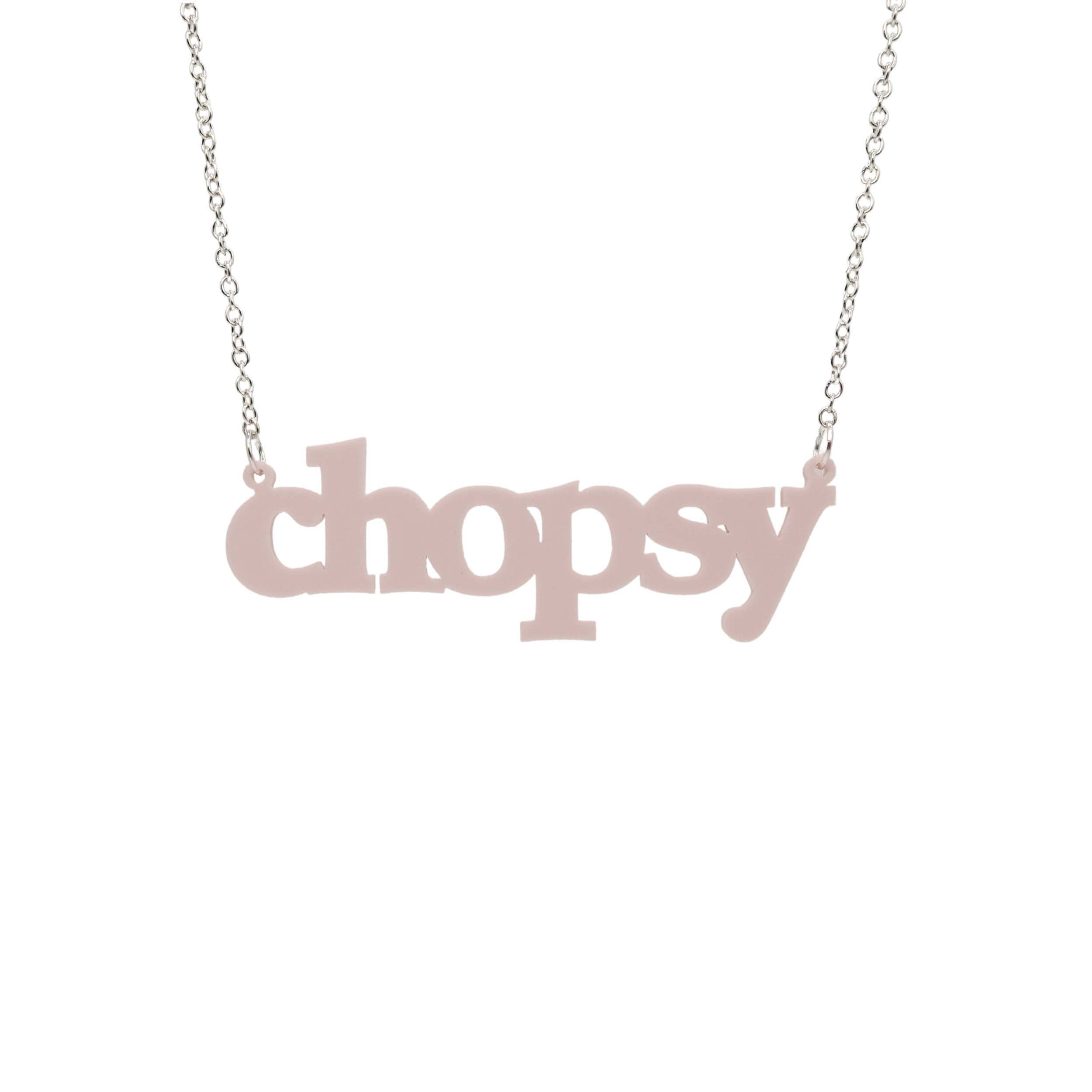 Chalk pink Chopsy necklace shown hanging against a white backround. 