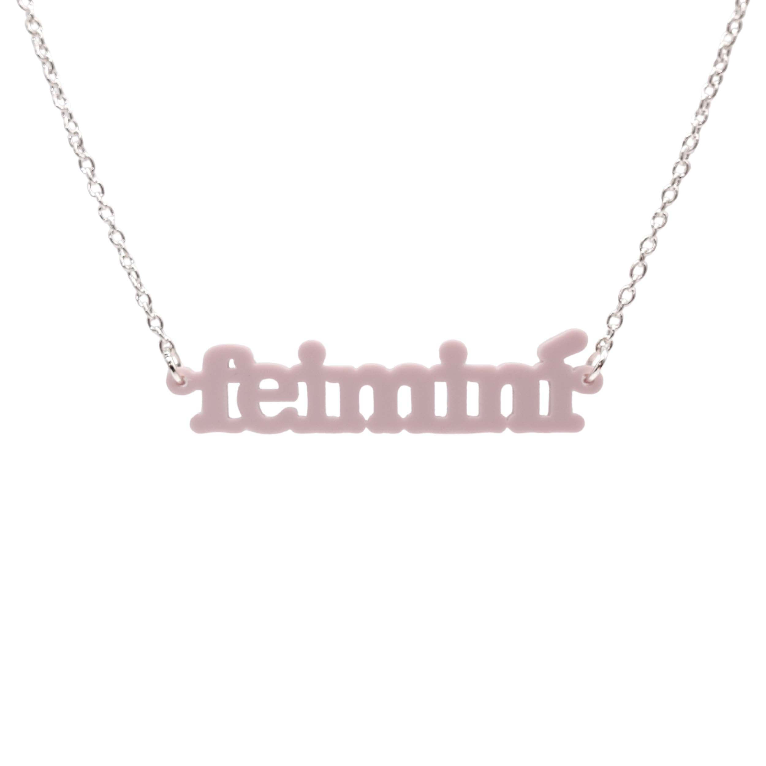 Irish Gaelic Feiminí necklace in chalk pink, shown hanging against a white background. 