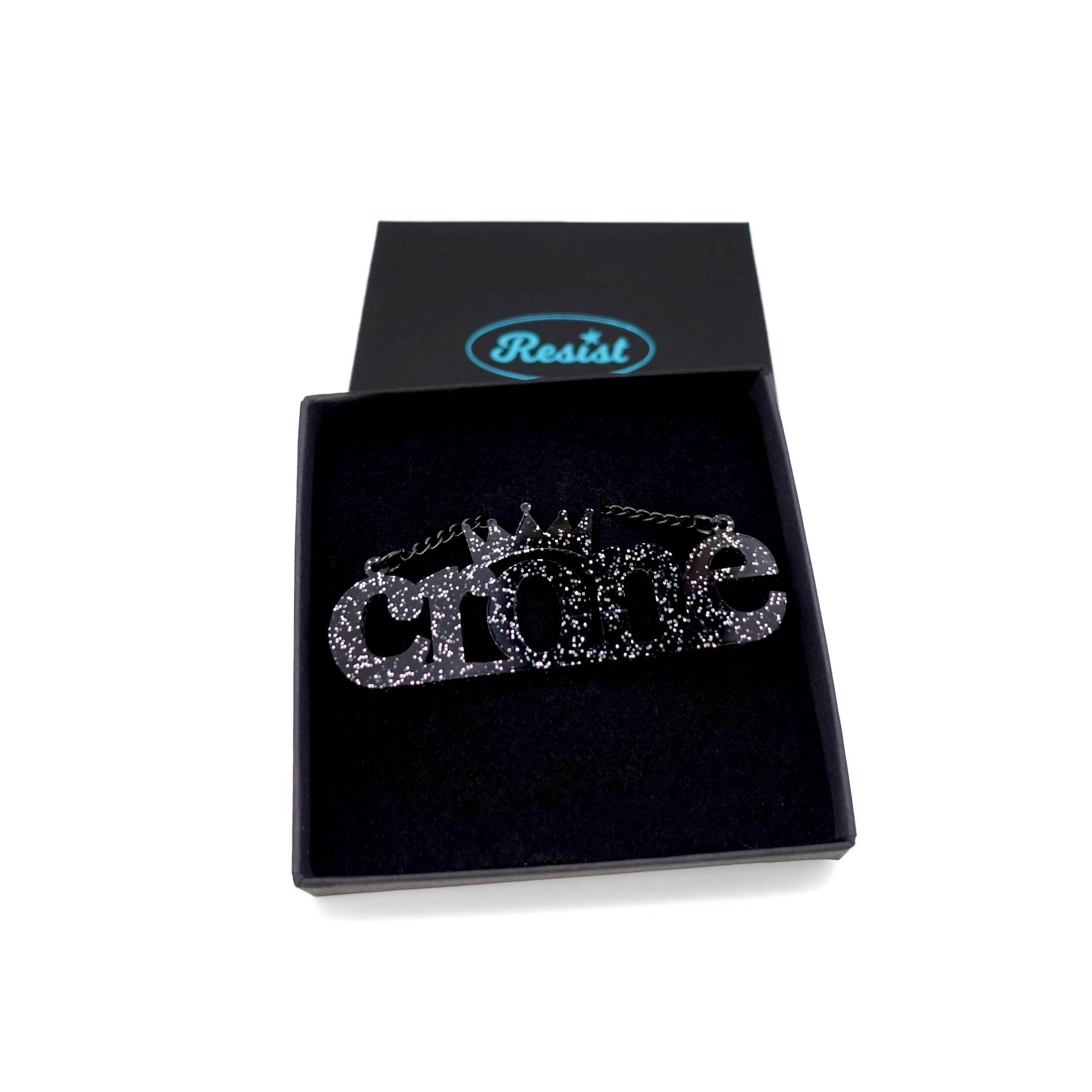 Crone necklace in black glitter, shown in a Wear and Resist gift box. 