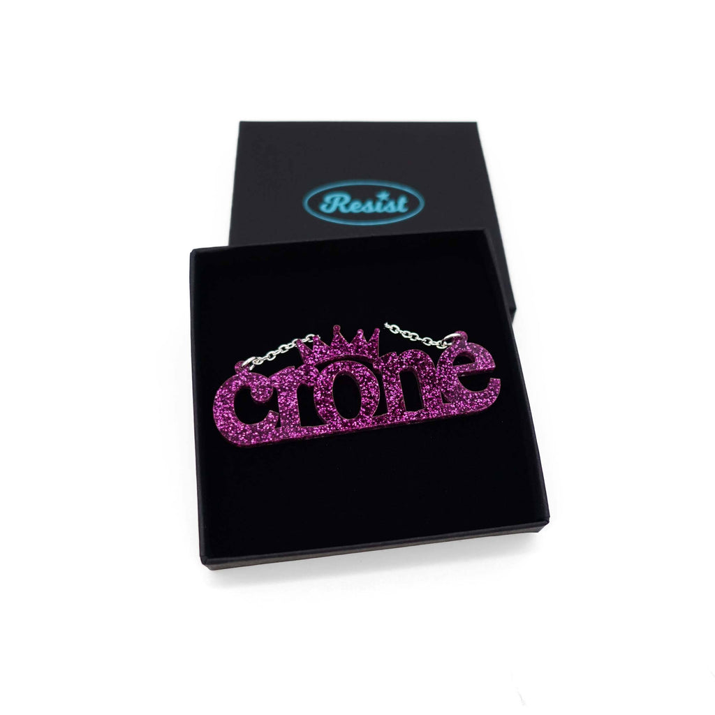Crone necklace in purple glitter, shown in a Wear and Resist gift box. 
