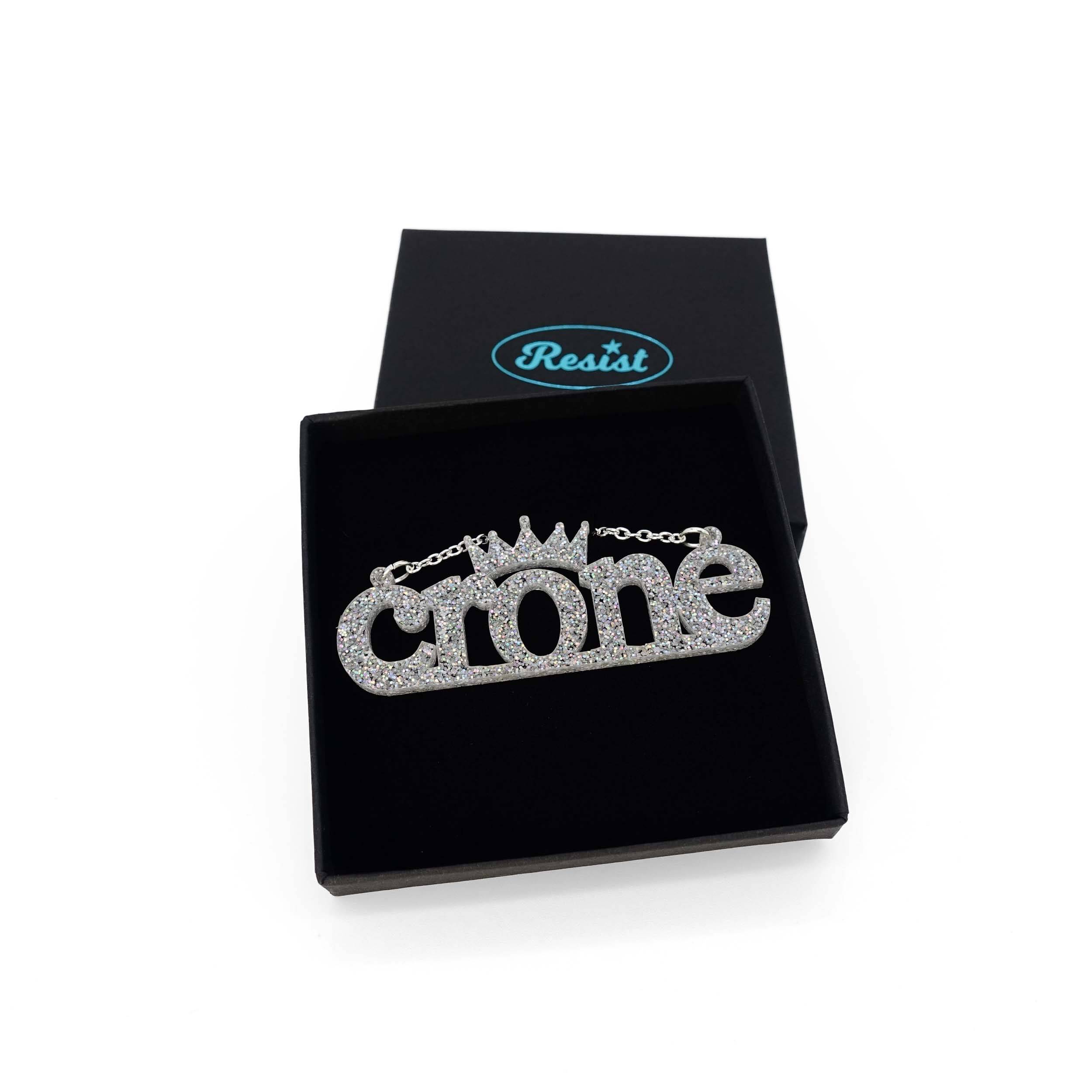 Crone necklace in silver glitter, shown in a Wear and Resist gift box. 