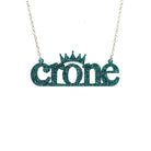 Crone necklace in teal glitter, shown hanging against a white background. 