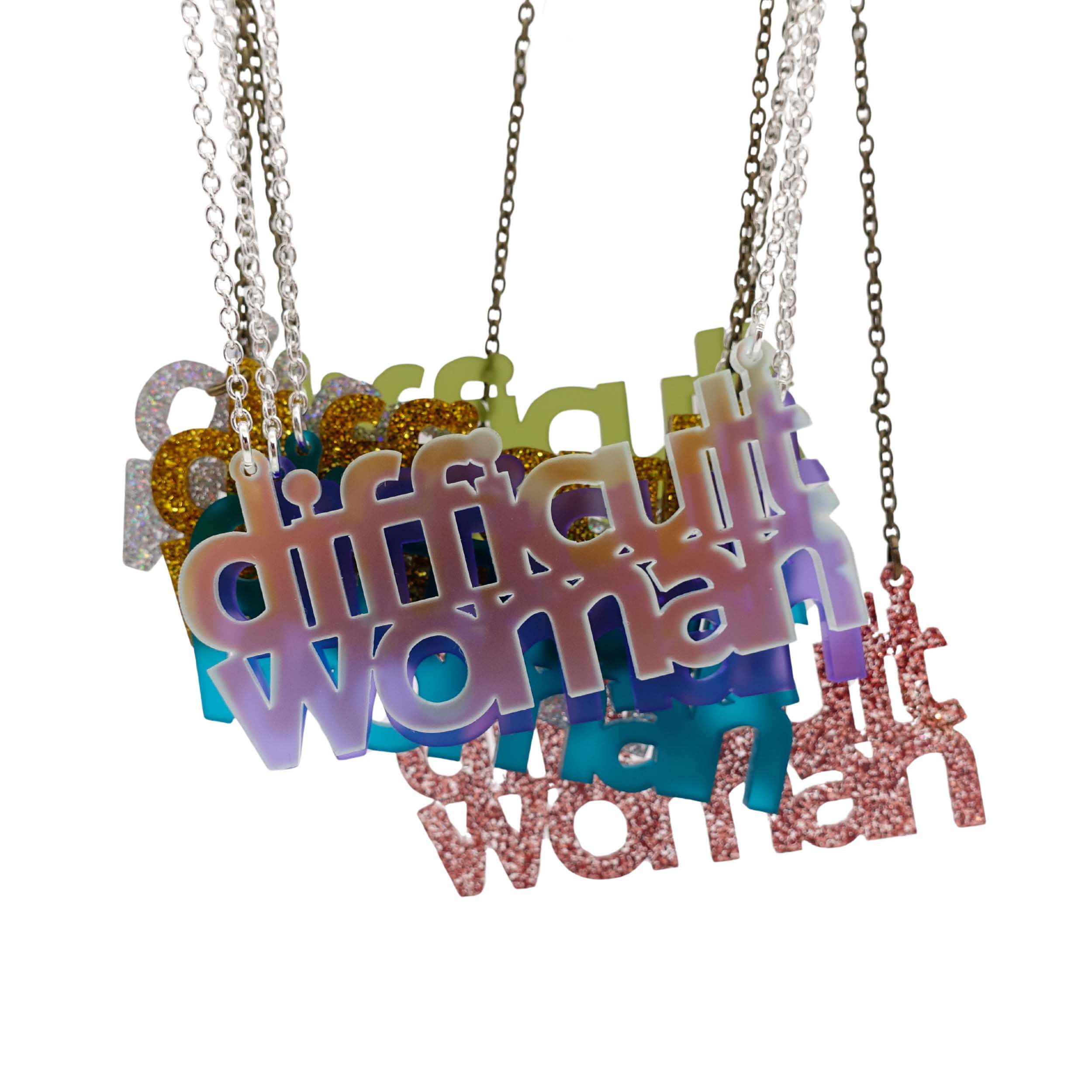 New colours of Difficult Woman necklaces hanging together with matte iridescent in front. 