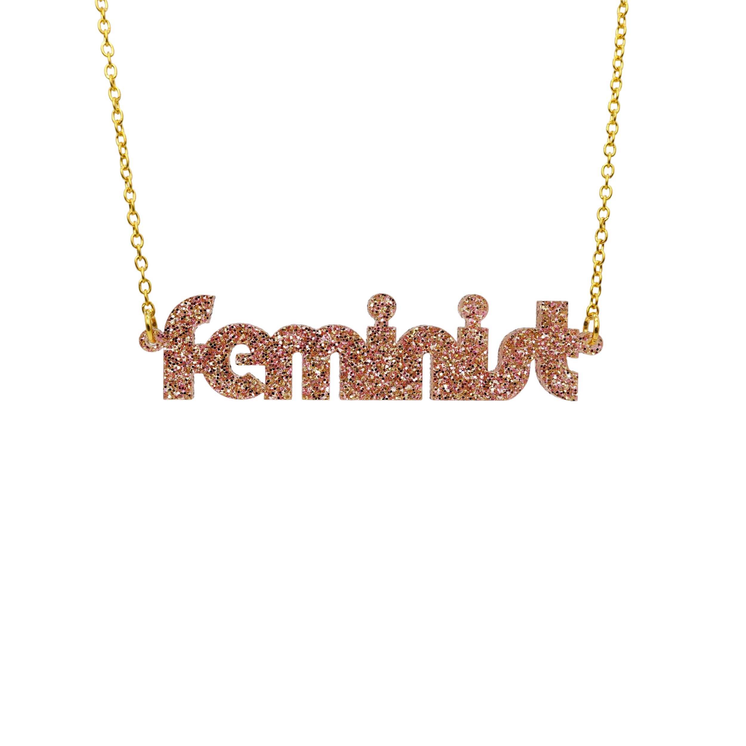 Disco feminist necklace in pink fizz glitter, shown hanging against a white background.
