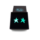 Electric green mirror funky Resist star earrings shown in a Wear and Resist gift box. 