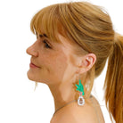 Eliza wears the RUDE BIRD earrings in green with birds holding silver 'jewels' that say 'Nah' and 'Nope'. 