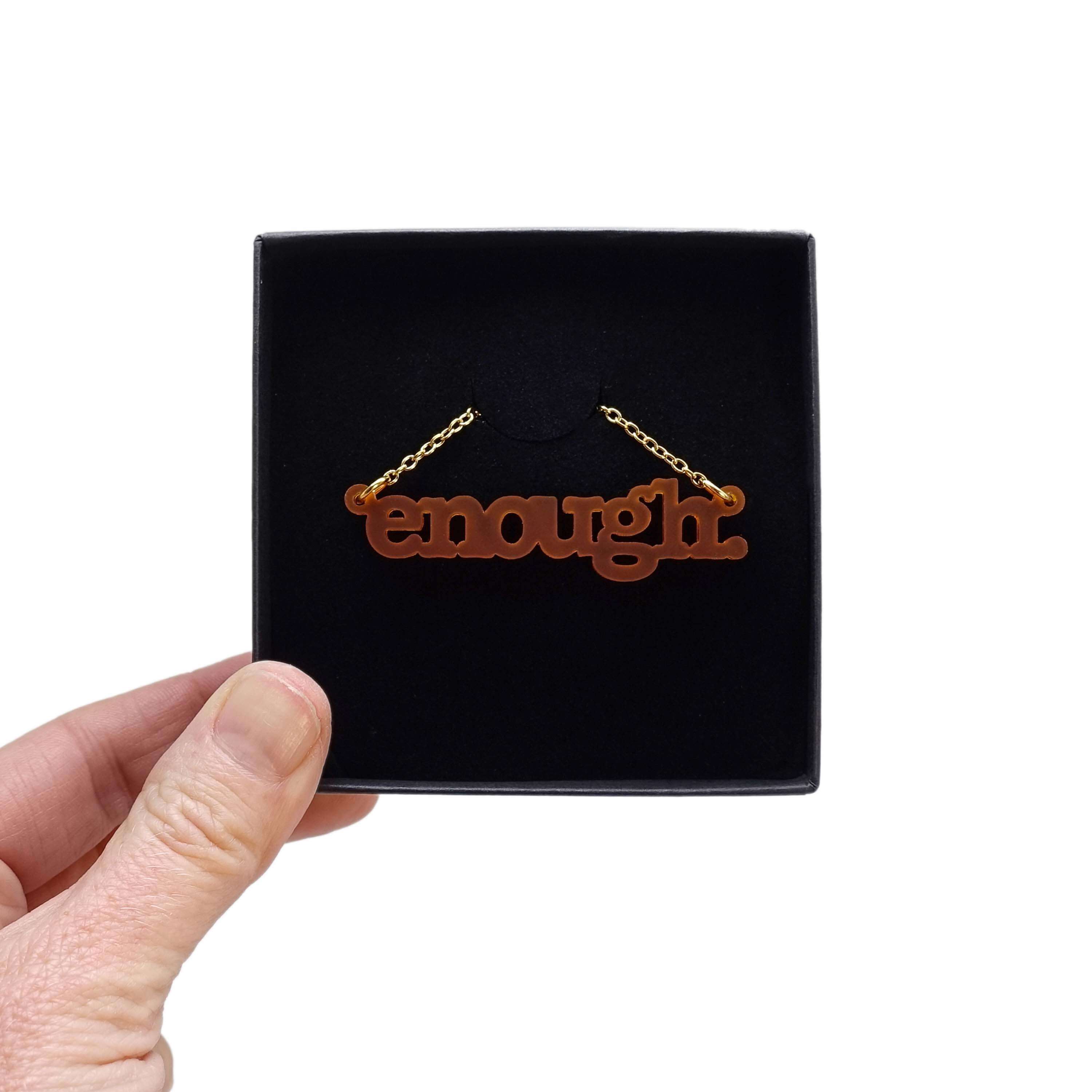 Typewriter Enough necklace in cider frost shown in a Wear and Resist gift box. 