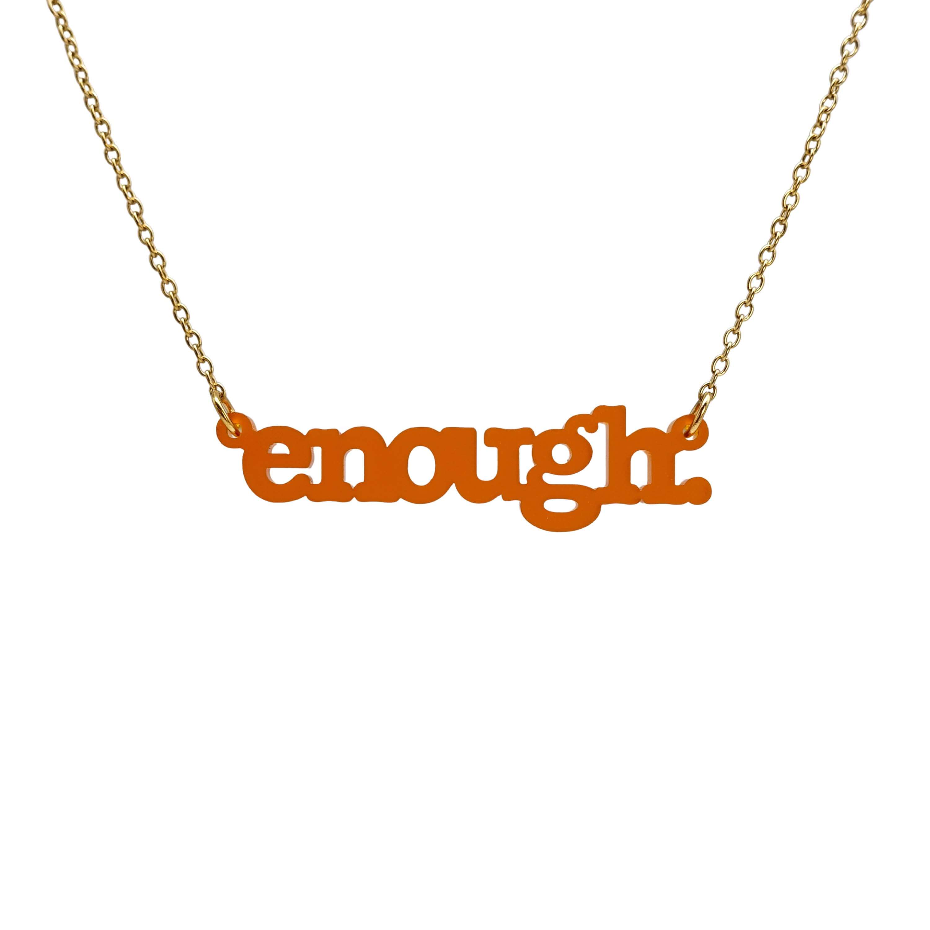 Typewriter Enough necklace in cider frost shown hanging on a gold-plated stainless steel chain against a white background. 