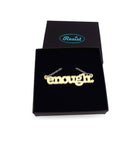 Typewriter Enough necklace in matte iridescent shown in a Wear and Resist gift box. 