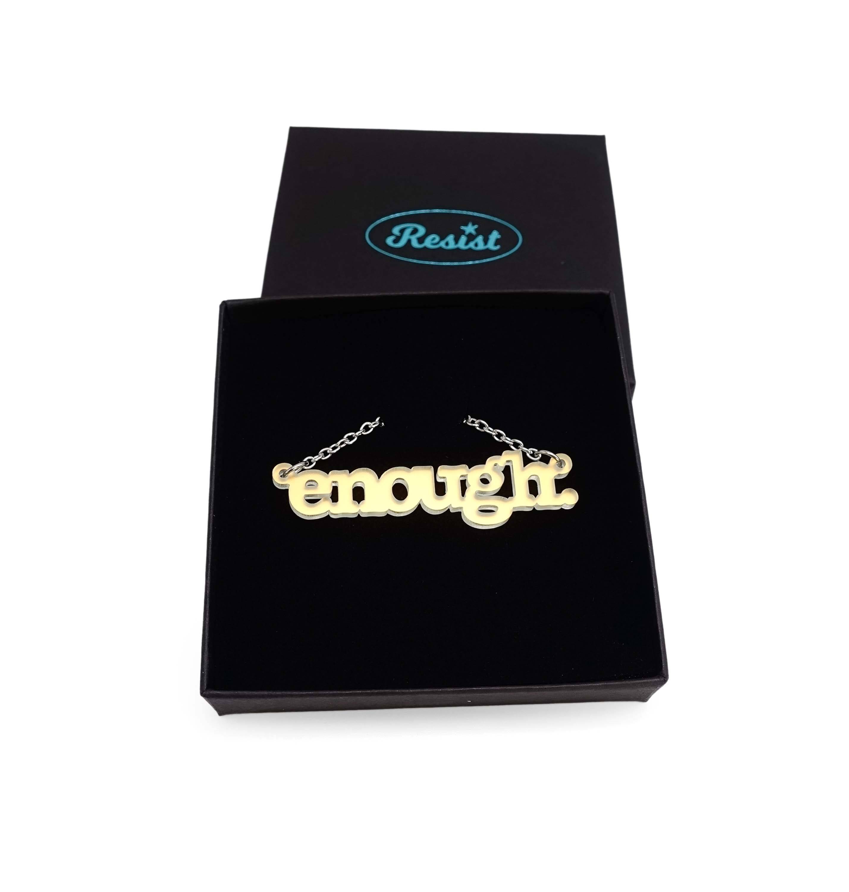 Typewriter Enough necklace in matte iridescent shown in a Wear and Resist gift box. 