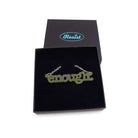 Typewriter Enough necklace in olive frost shown in a Wear and Resist gift box. 