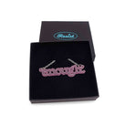 Typewriter Enough necklace in pink frost shown in a Wear and Resist gift box. 