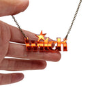 Witch necklace in flame mirror shown hanging against a white background with my hand for size. Not just for Halloween! 