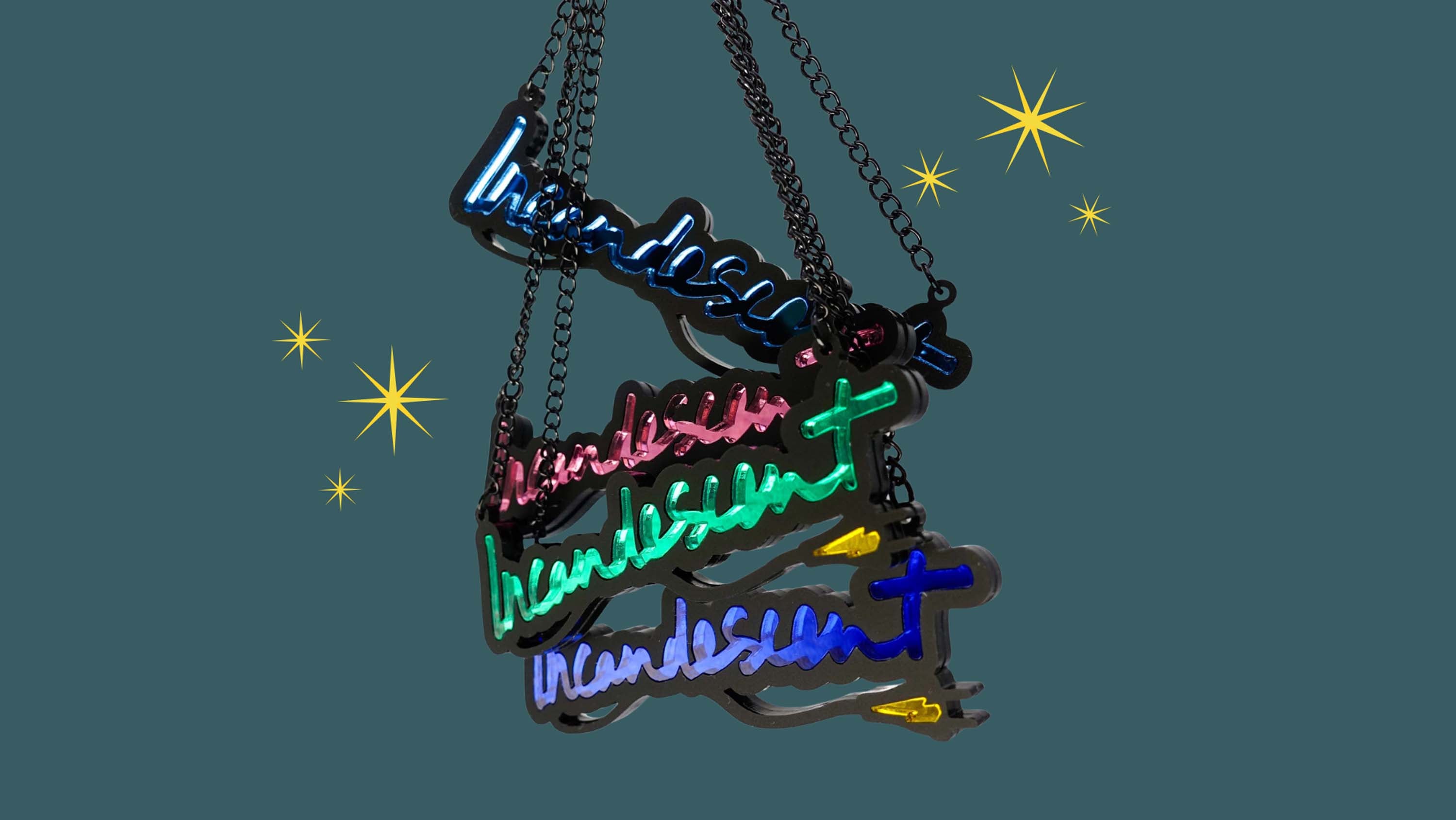 Incandescent necklaces shown hanging against a starry background. 