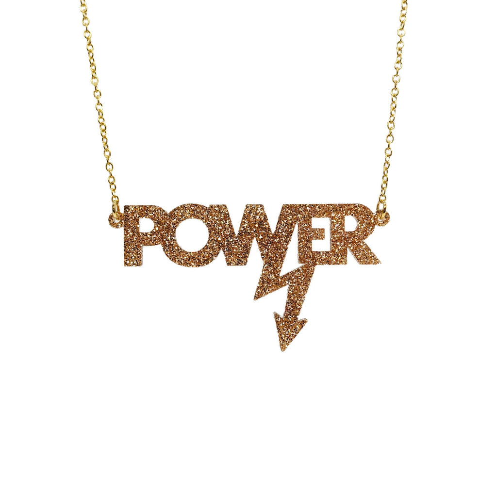 Gold glitter large Power necklace, designed in collaboration with Mary Beard to celebrate her book, Women & Power. 