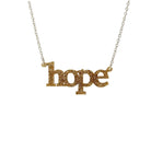 Hope necklace in gold glitter shown on a silver chain hanging on a white background. 