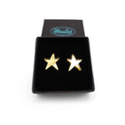 Gold green mirror funky Resist star earrings shown in a Wear and Resist gift box. 