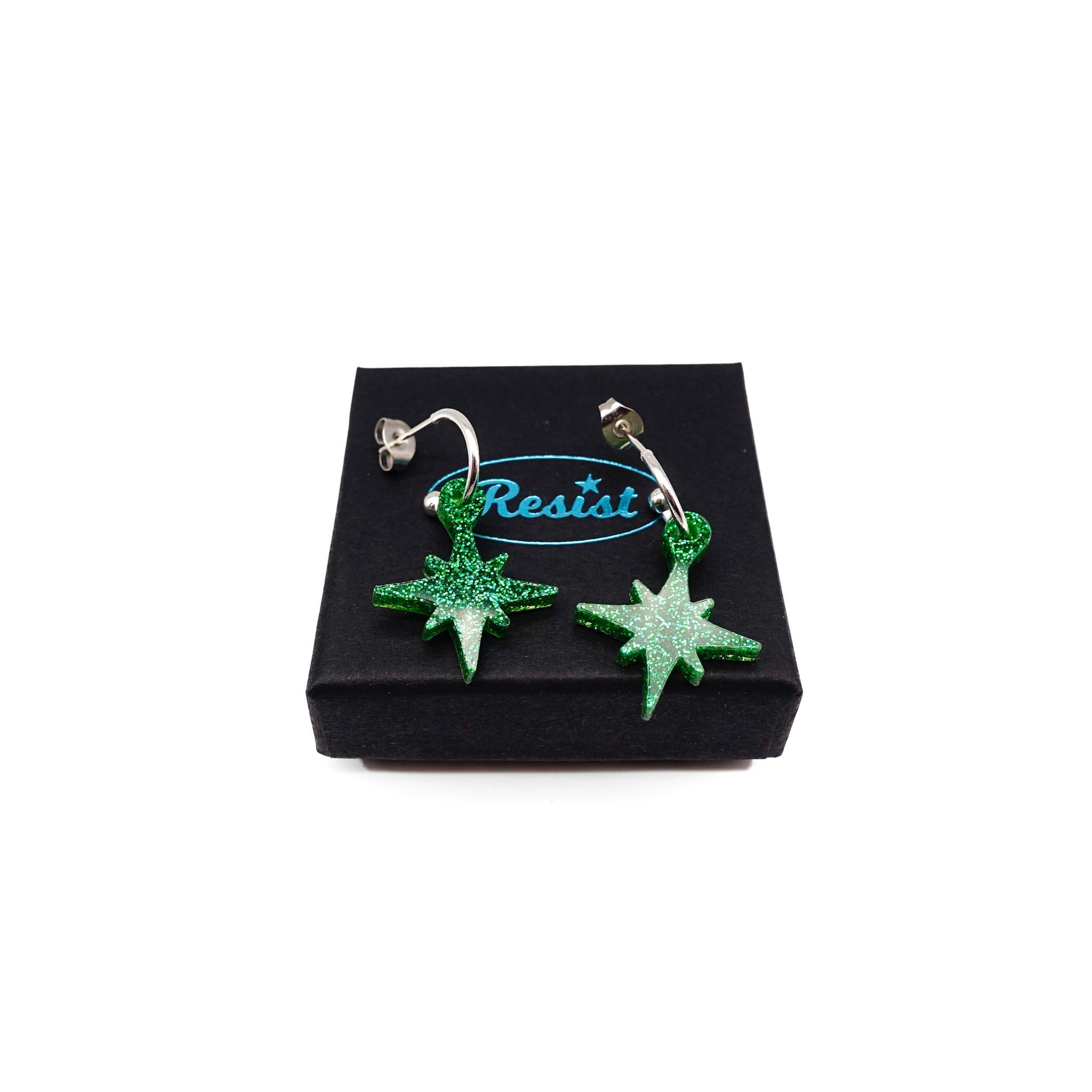 Green glitter limited edition Festive Vintage Star earrings, shown on a Wear and Resist gift box.  