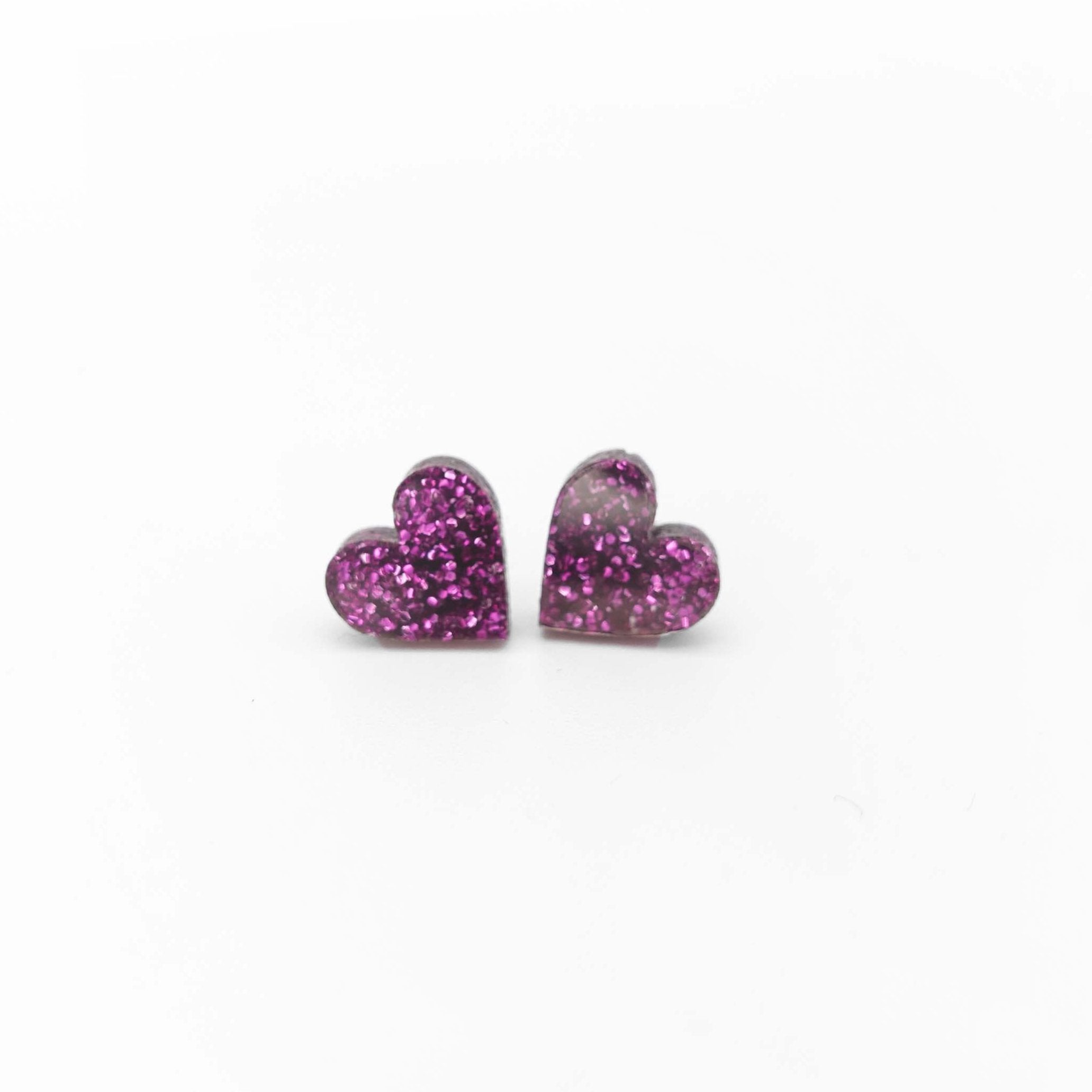 Little heart earrings in purple glitter. For all you total queens. 