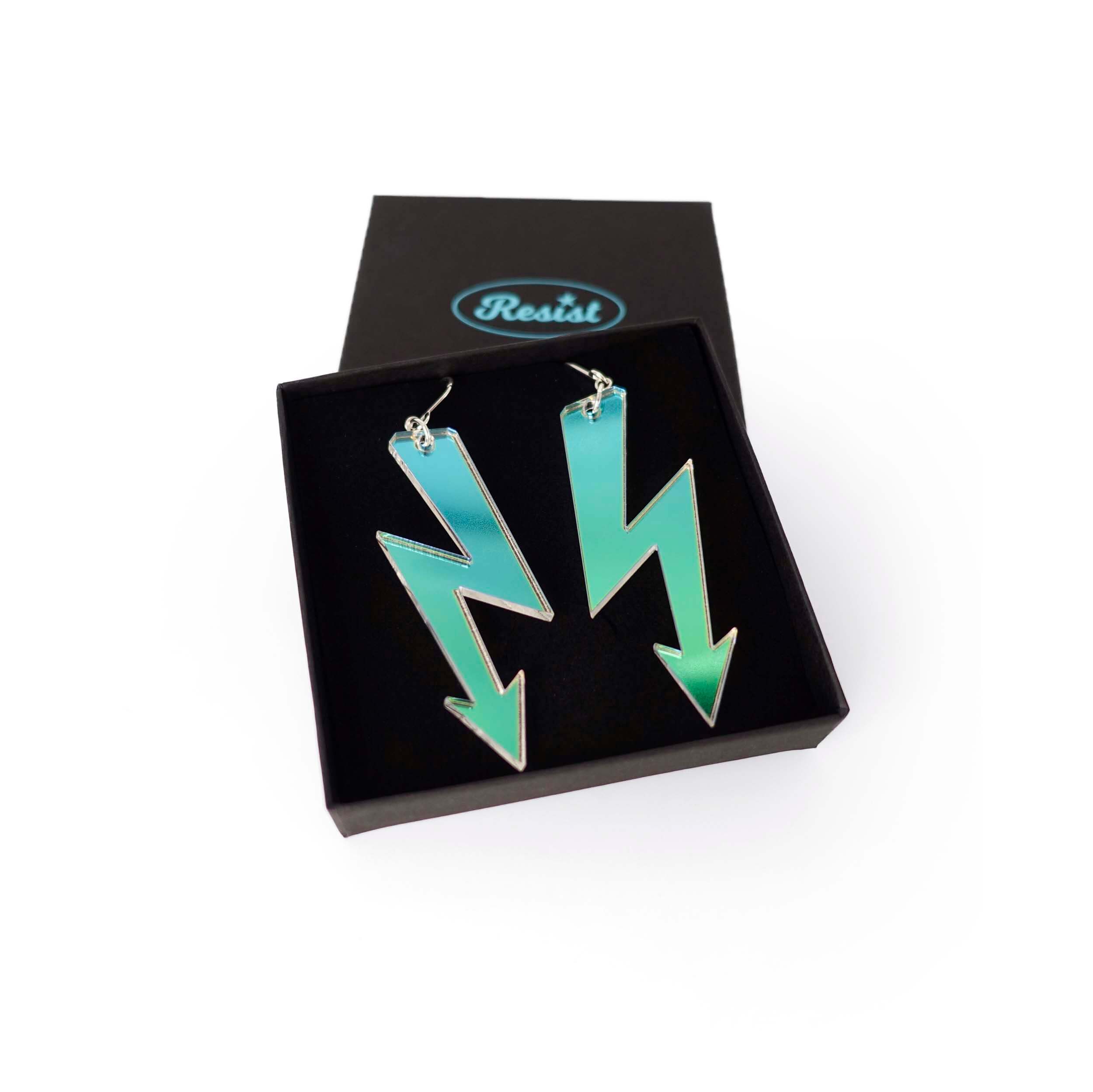 Iridescent high voltage earrings shown in a Wear and Resist gift box. 