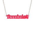 Hot pink  Feminist necklace shown hanging on a white background. 