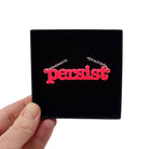 Hot pink Persist necklace shown in a Wear and Resist gift box. 