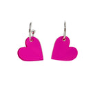 Neon pink simple heart hoop earrings on silver-plated hoops. Shown hanging against a white background.  