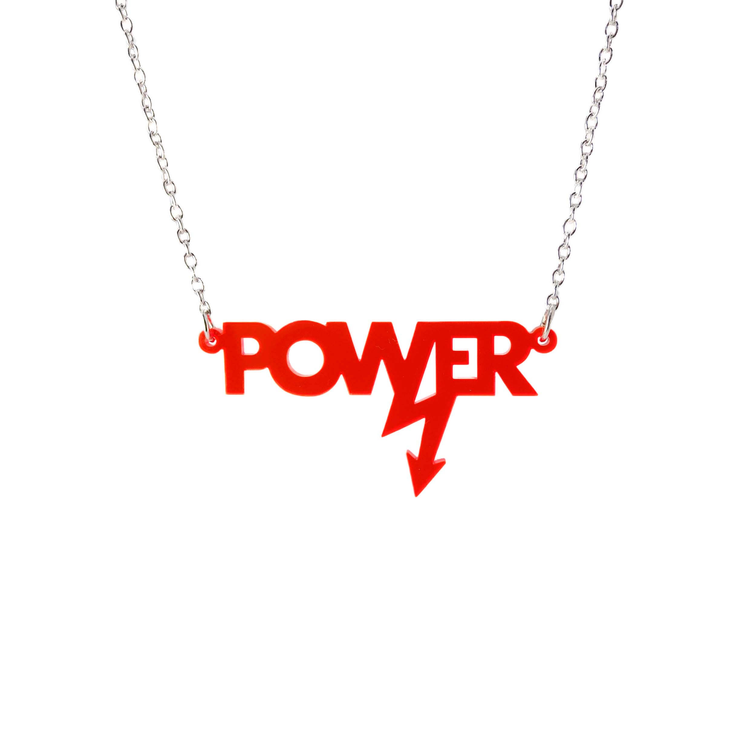 Mini power necklace in hot red shown hanging on a silver chain against a white background. Designed in collaboration with Mary Beard for her book Women and Power. 