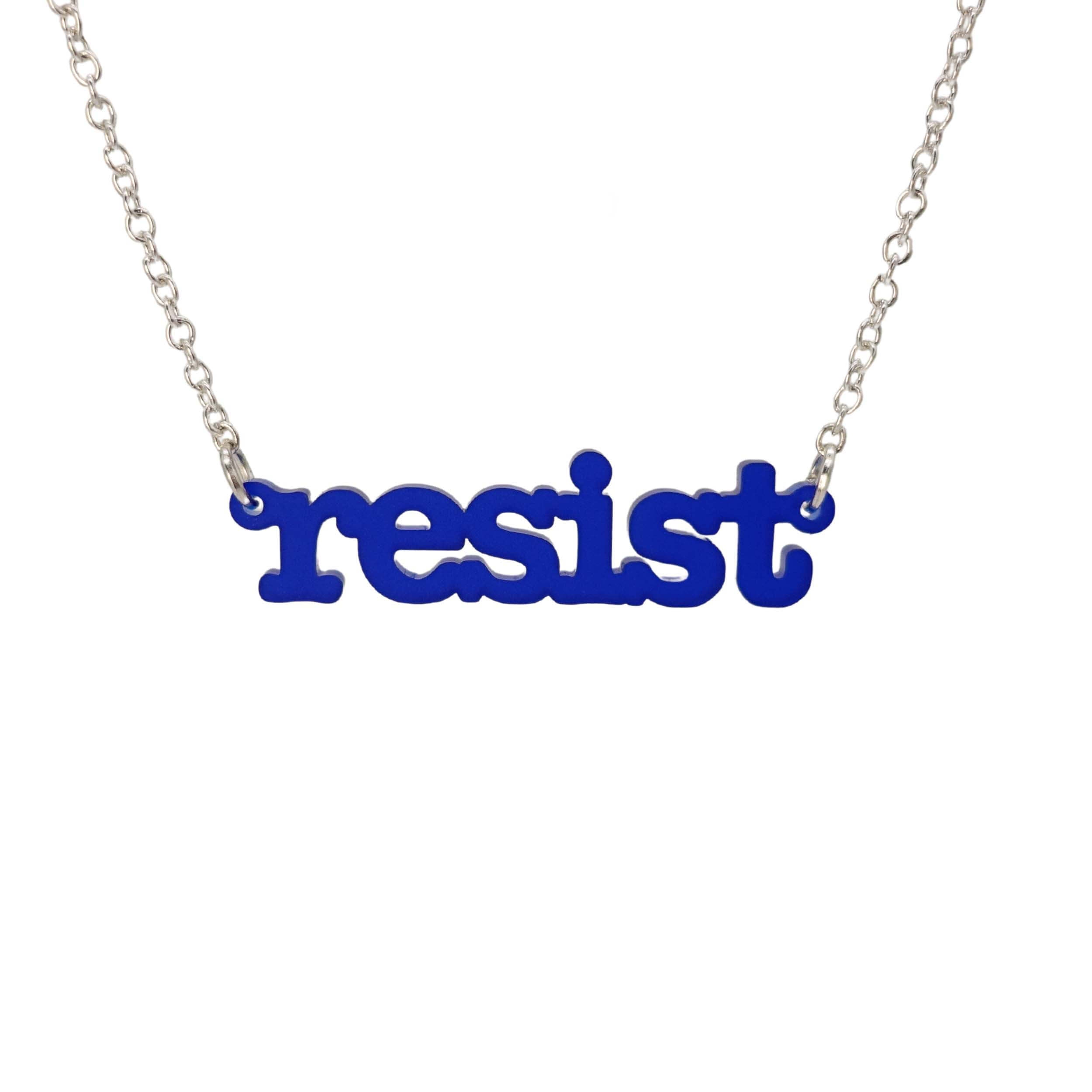 Indigo frost Resist necklace in typewriter font hanging on a silver chain against a white background. 