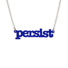 Indigo frost Persist necklace in typewriter font hanging on a silver chain against a white background. 