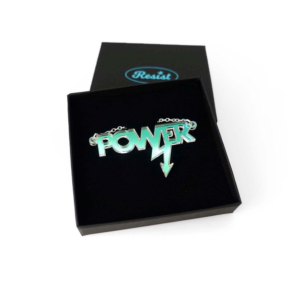 Mini power necklace in iridescent shown in a Wear and Resist gift box. 
