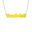 Lemon  Feminist necklace shown hanging on a white background. 