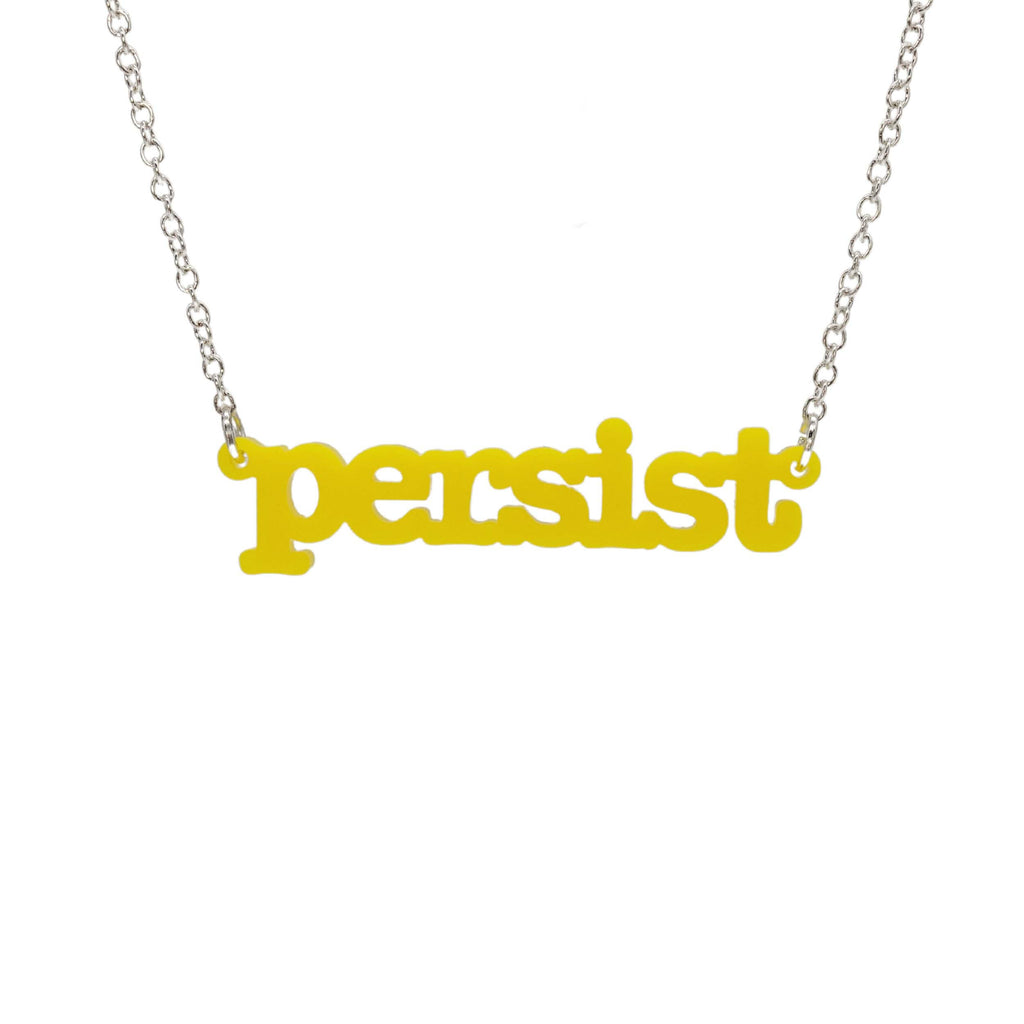 Lemon Persist necklace in typewriter font hanging on a silver chain against a white background. 