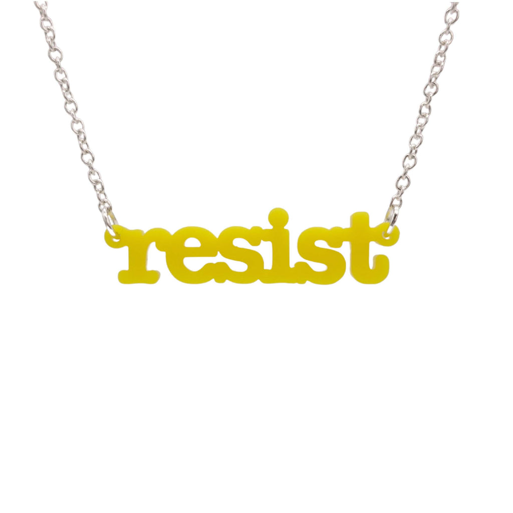 Lemon Resist necklace in typewriter font hanging on a silver chain against a white background. 