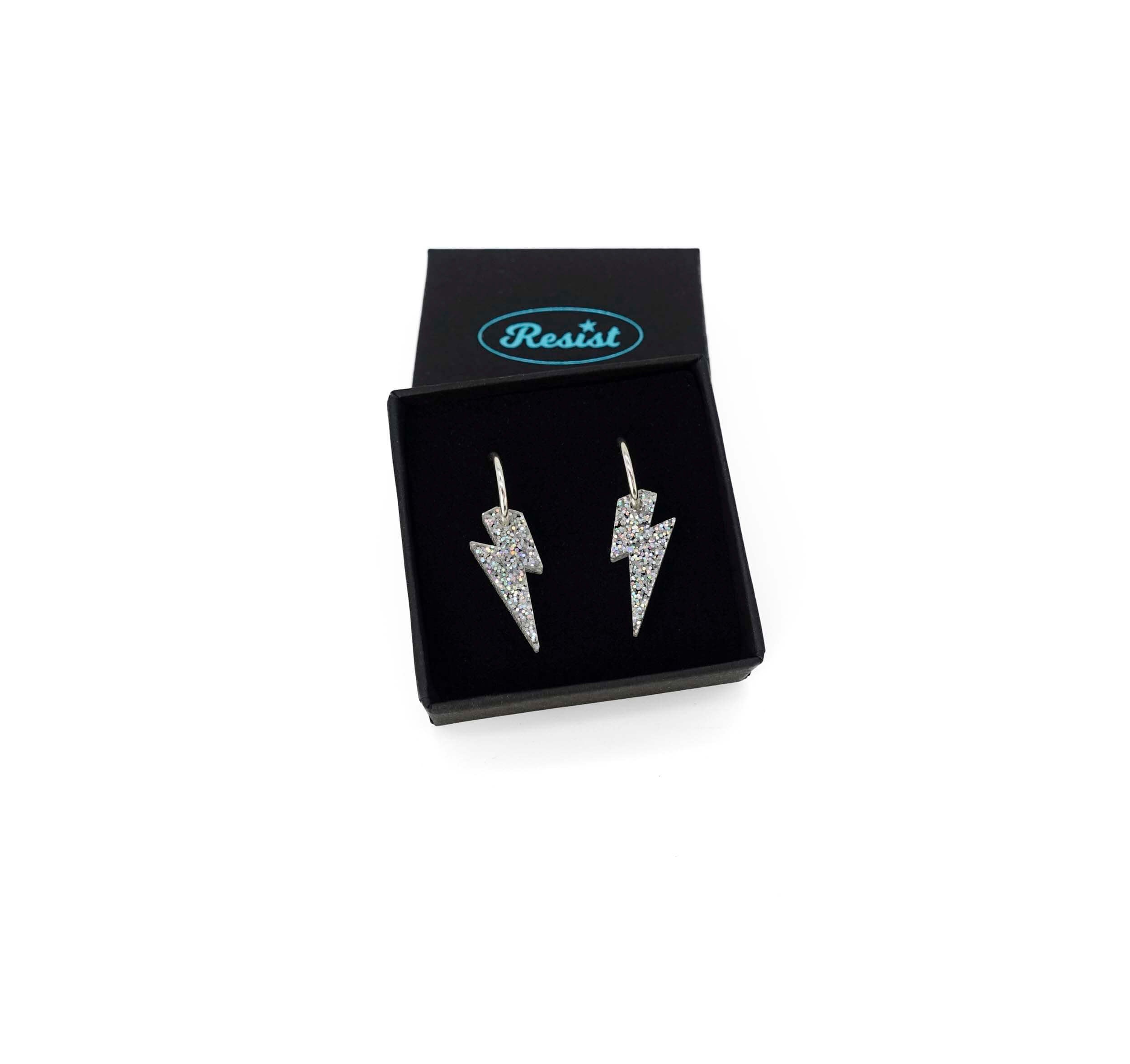 Lightning bolt hoop earrings in silver glitter in a Wear and Resist gift box. 