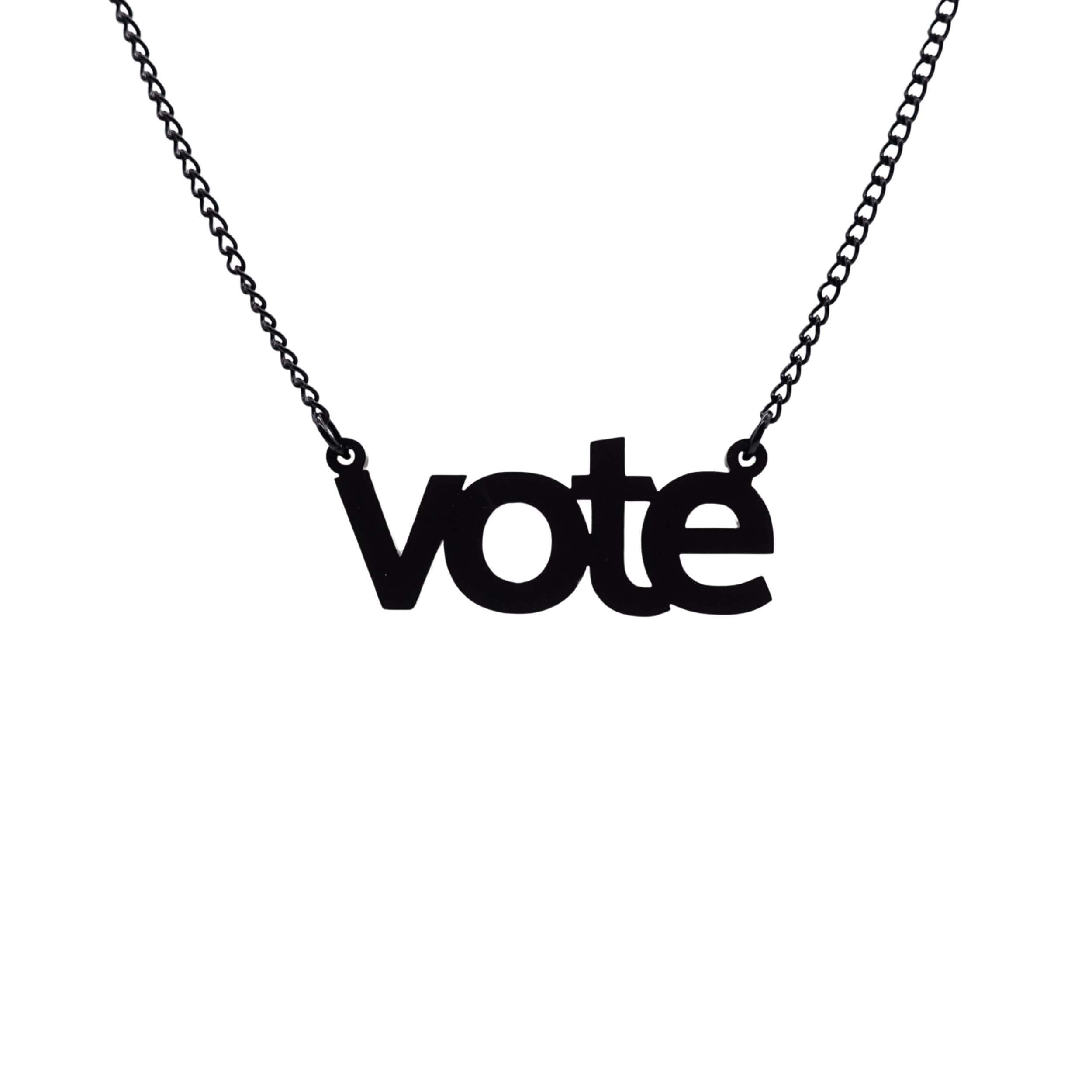 Vote necklace in matte black shown hanging against a white background. 