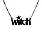 Witch necklace in matte black on a black chain shown hanging against a white background. 