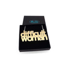 Difficult Woman necklace in matte iridescent, shown in a Wear and Resist gift box.