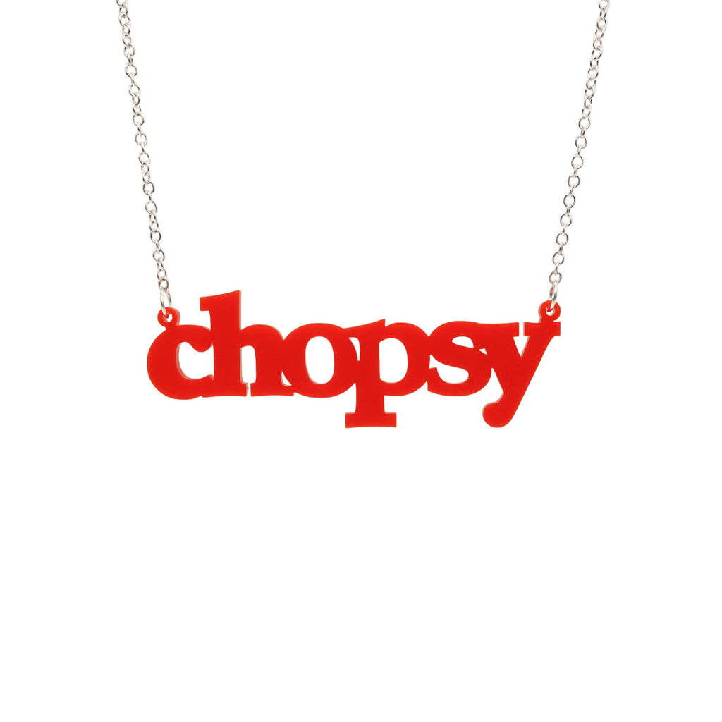 Matte red Chopsy necklace shown hanging against a white backround. 