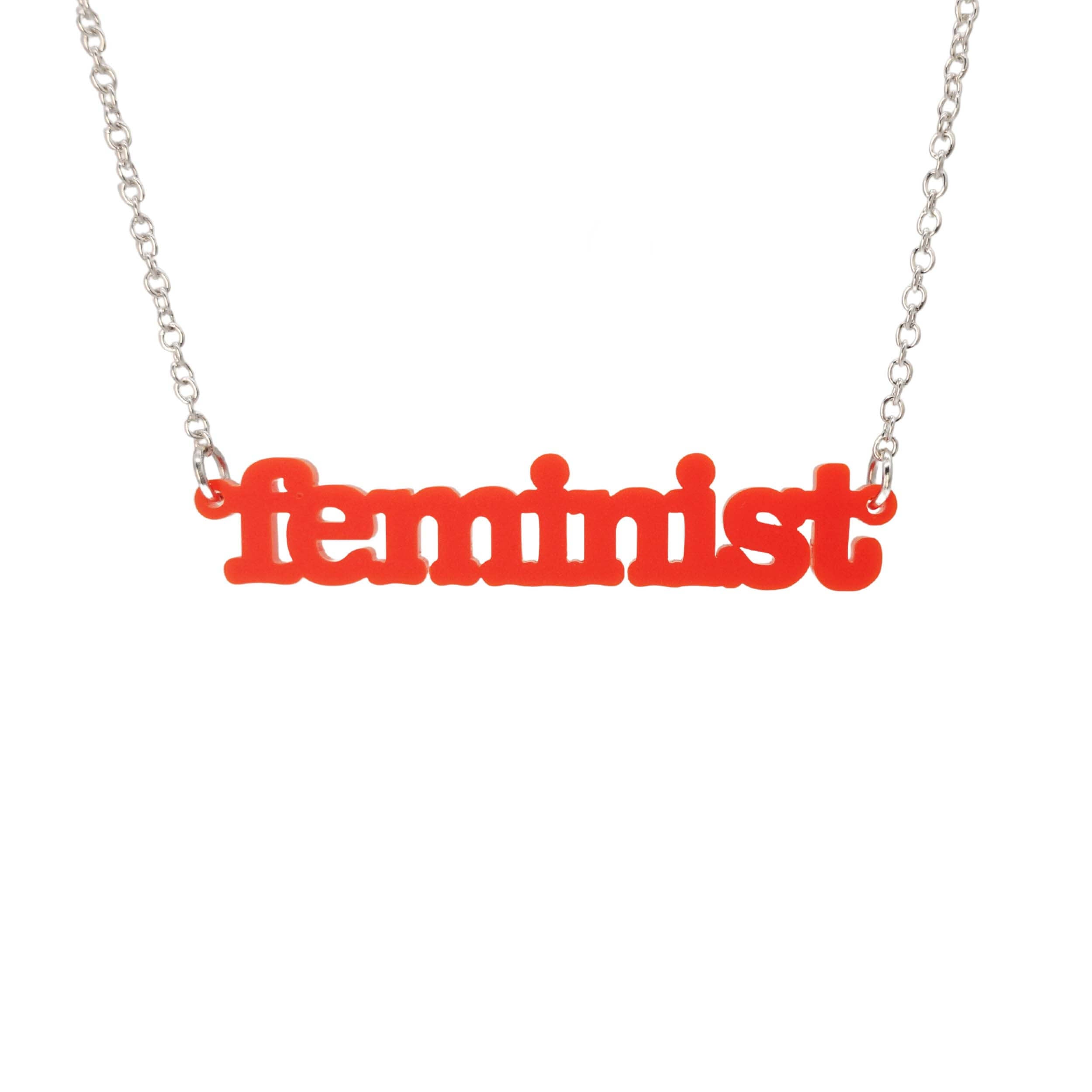 Matte red Feminist necklace shown hanging on a white background. 