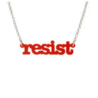Matte red Resist necklace in typewriter font hanging on a silver chain against a white background. 