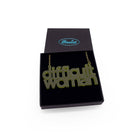 Difficult Woman necklace in olive frost, shown in a Wear and Resist gift box.