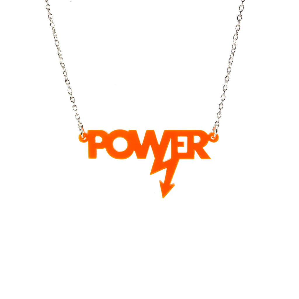 Mini power necklace in flouro orange shown hanging on a silver chain against a white background. Designed in collaboration with Mary Beard for her book Women and Power. 