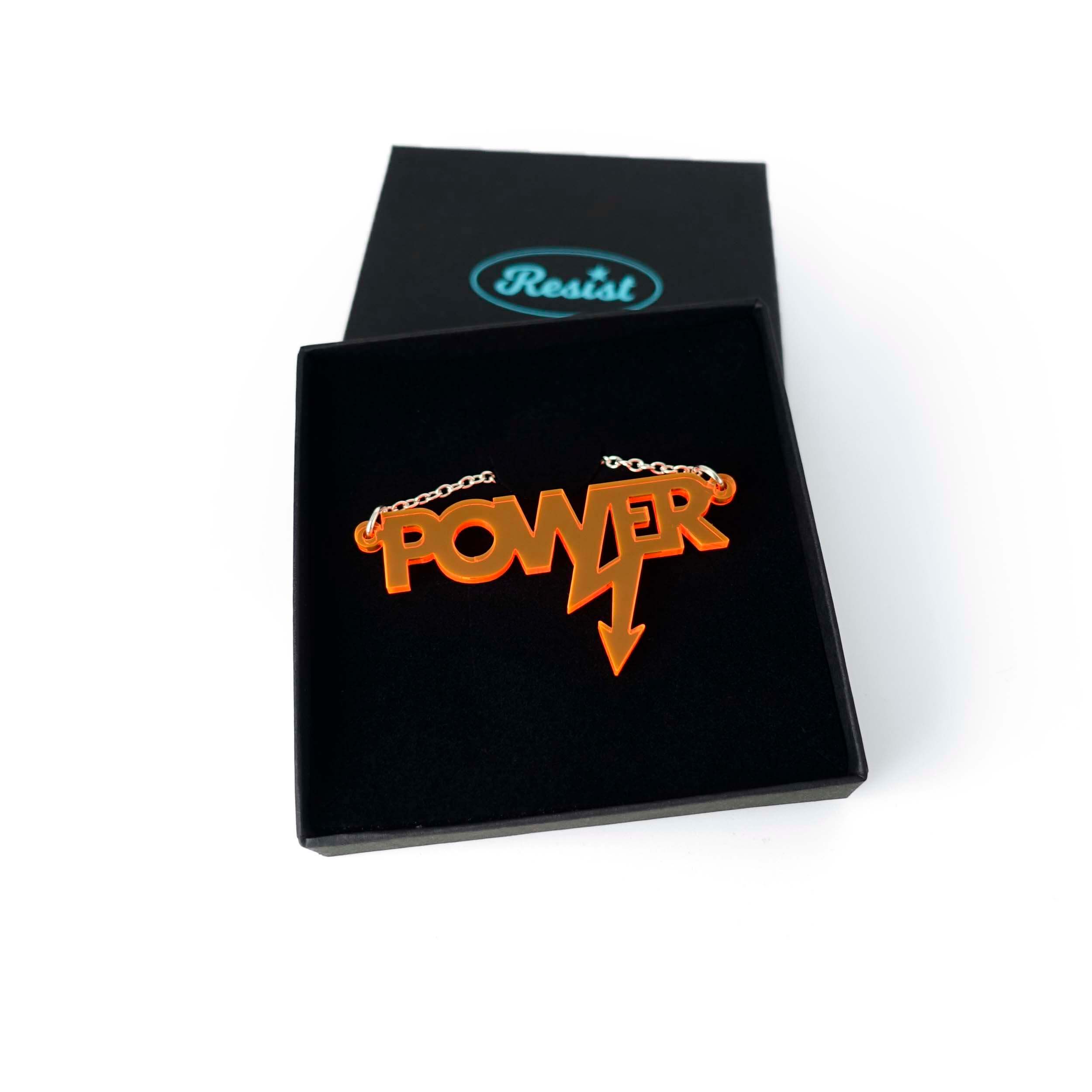 Mini power necklace in fluoro orange shown in a Wear and Resist gift box. 