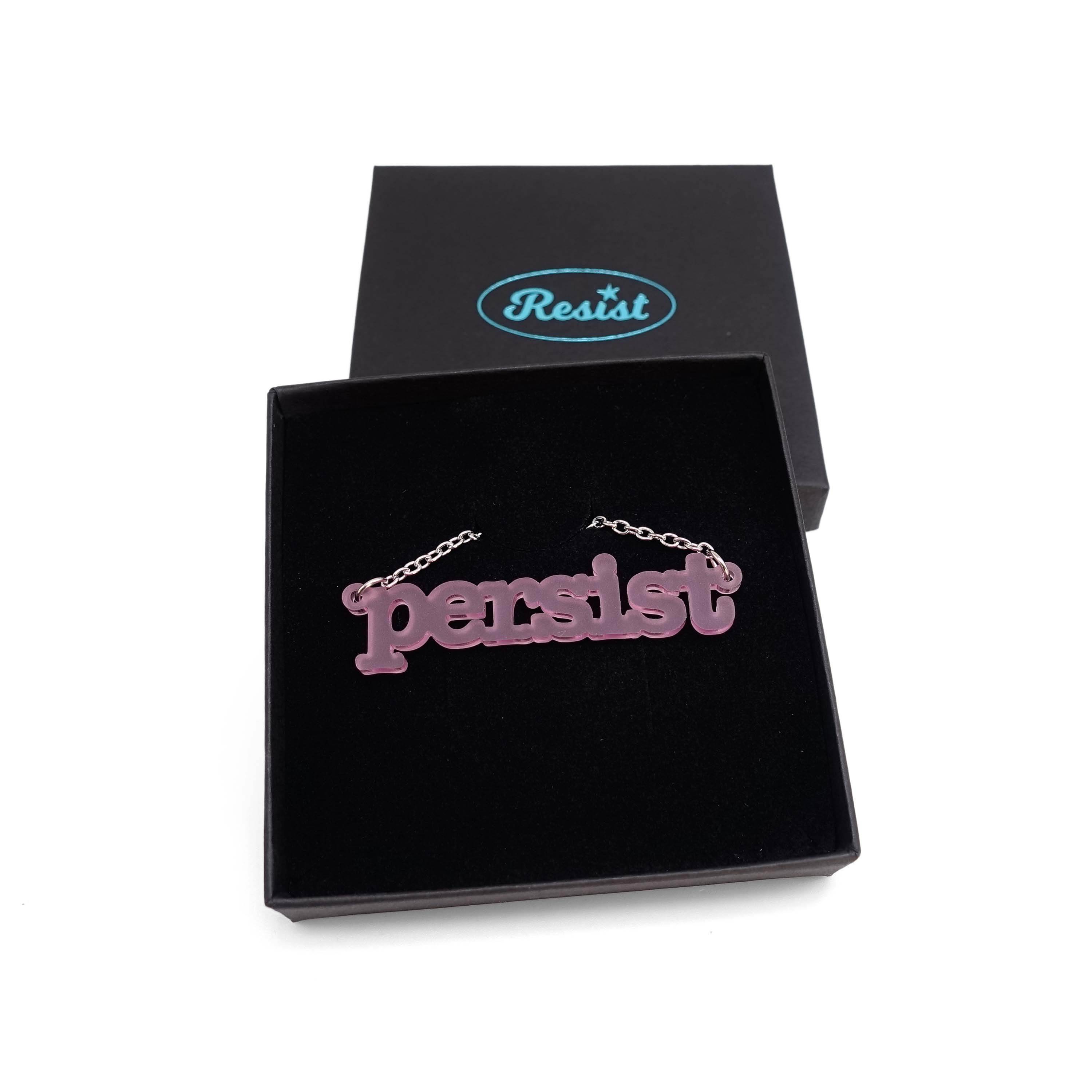 Typewriter Resist necklace in pink frost shown in a Wear and Resist gift box.
